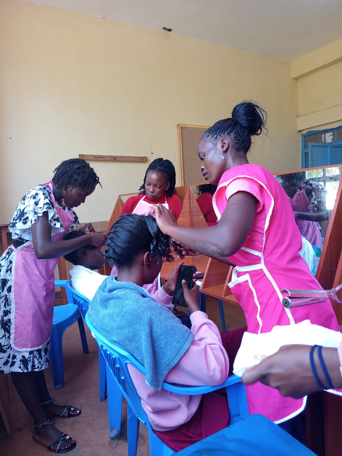 Trainees participating in hands-on learning at Ebukanga TVC